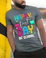 Happy First Day of School Colorful Teacher T-Shirt - model in grey shirt leaning against column