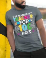 Bugged My Teacher for 100 Days T-Shirt Funny - model in grey shirt leaning against column