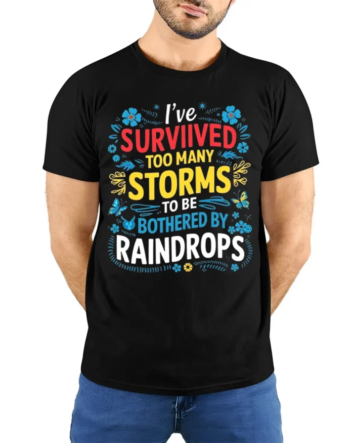 Survived Storms Raindrops Motivational Quote T-Shirt - model wearing black shirt, hands behind back