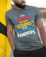 Survived Storms Raindrops Motivational Quote T-Shirt - model in grey shirt leaning against column