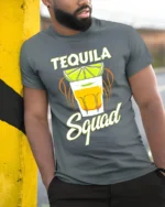 Tequila Squad Drinking Party T-Shirt for Summer Fun - model in grey shirt leaning against column