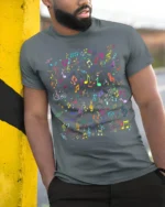 Colorful Music Notes Pattern Graphic T-Shirt - model in grey shirt leaning against column