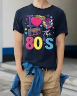 I Love the 80s T-shirt with Retro Icons Graphic - model wearing navy shirt, hands in pockets