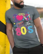 I Love the 80s T-shirt with Retro Icons Graphic - model in grey shirt leaning against column
