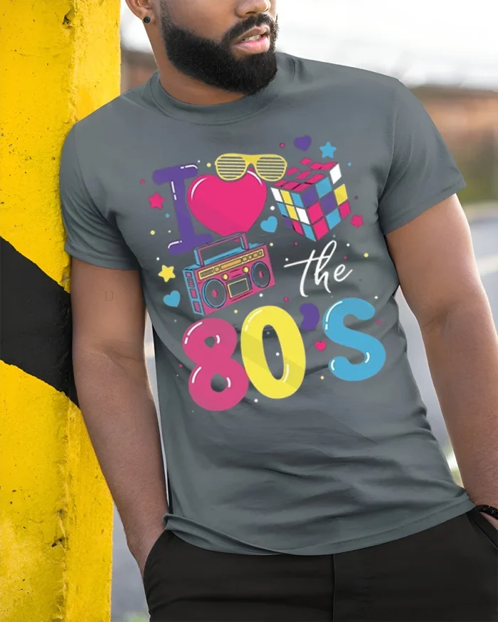 I Love the 80s T-shirt with Retro Icons Graphic - model in grey shirt leaning against column