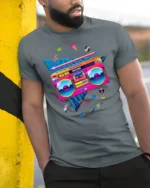 Retro Neon Boombox T-shirt with 80s Vibe Art - model in grey shirt leaning against column