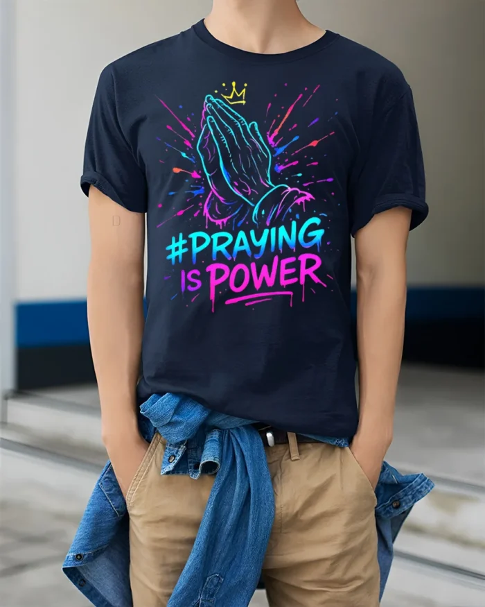 Praying Hands Faith Power Graphic T-shirt - model wearing navy shirt, hands in pockets