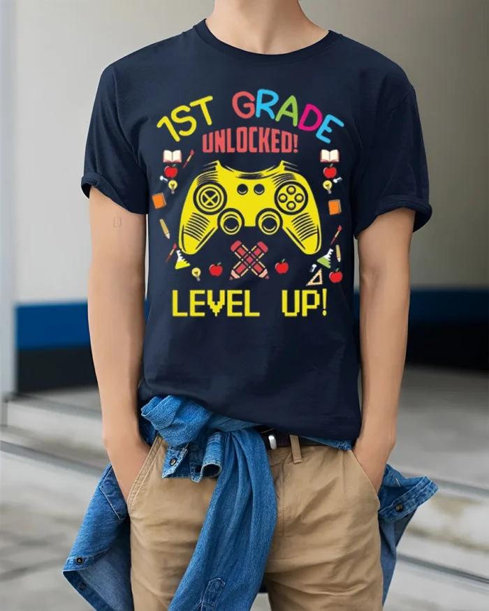 1st Grade Unlocked Gamer Back to School T-shirt - model wearing navy shirt, hands in pockets