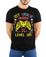 1st Grade Unlocked Gamer Back to School T-shirt - model wearing black shirt, hands behind back