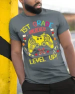 1st Grade Unlocked Gamer Back to School T-shirt - model in grey shirt leaning against column