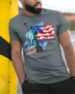 Statue of Liberty American Flag T-shirt USA - model in grey shirt leaning against column