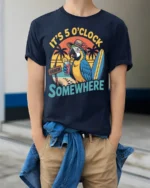 It’s 5 O’Clock Somewhere Beach T-Shirt - model wearing navy shirt, hands in pockets