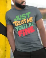 Just Trust Me You’ll Be Fine T-Shirt - model in grey shirt leaning against column