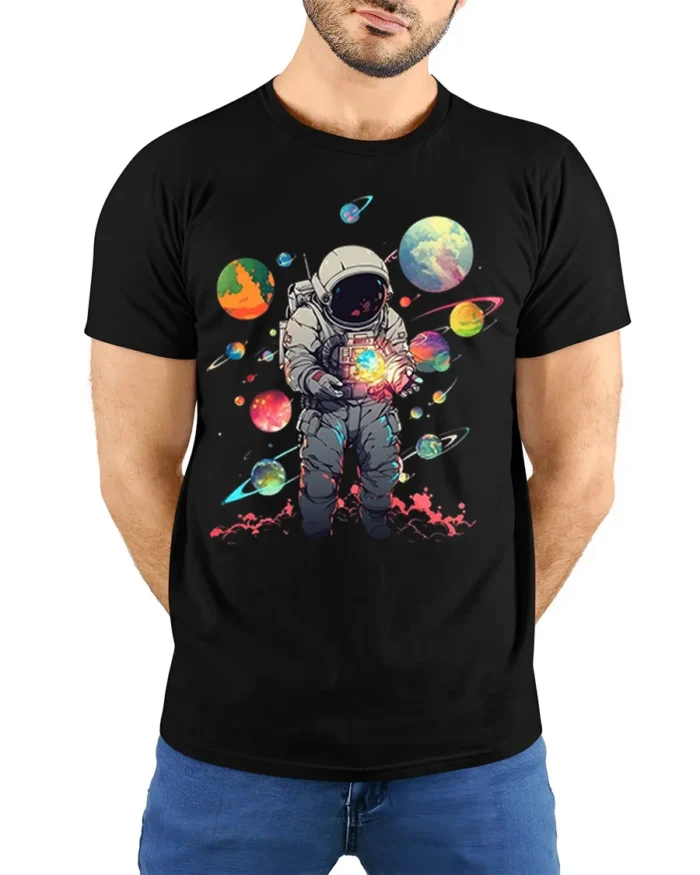 Cosmic Astronaut Holding Planets Space T-Shirt - model wearing black shirt, hands behind back