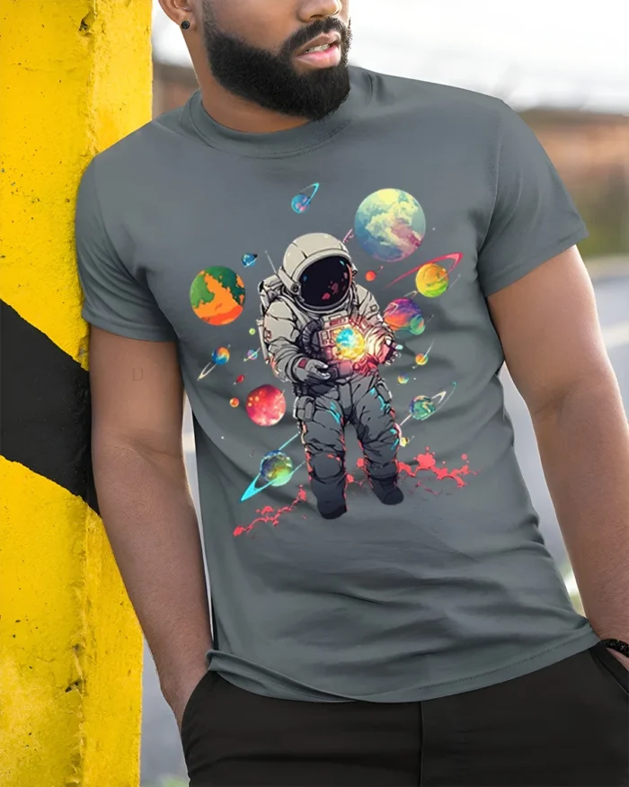 Cosmic Astronaut Holding Planets Space T-Shirt - model in grey shirt leaning against column