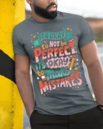 It’s Okay to Make Mistakes Positive Quote T-Shirt - model in grey shirt leaning against column