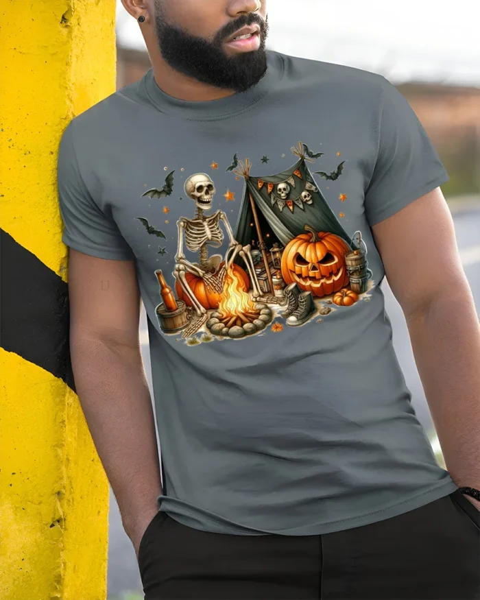 Skeleton Pumpkin Campfire Halloween T-Shirt - model in grey shirt leaning against column