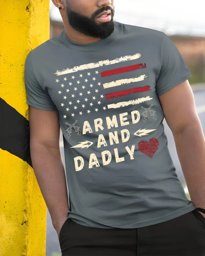 Armed and Dadly American Flag Patriotic T-shirt - model in grey shirt leaning against column