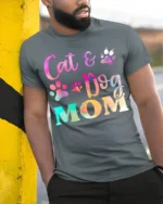 Colorful Cat and Dog Mom Paw Print Graphic T-shirt - model in grey shirt leaning against column