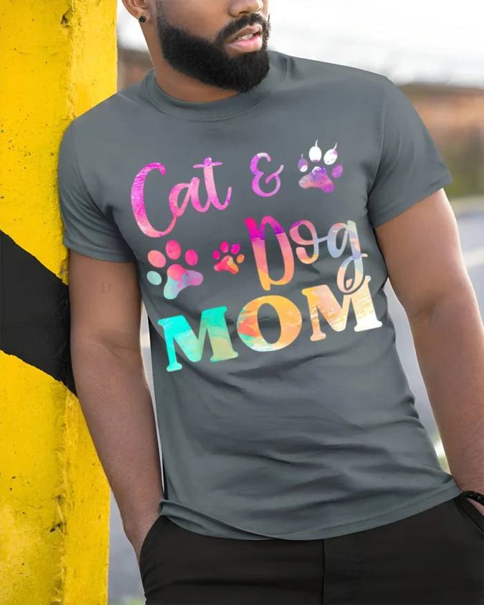 Colorful Cat and Dog Mom Paw Print Graphic T-shirt - model in grey shirt leaning against column