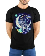 Astronaut Sitting on Moon Space Planets T-shirt - model wearing black shirt, hands behind back