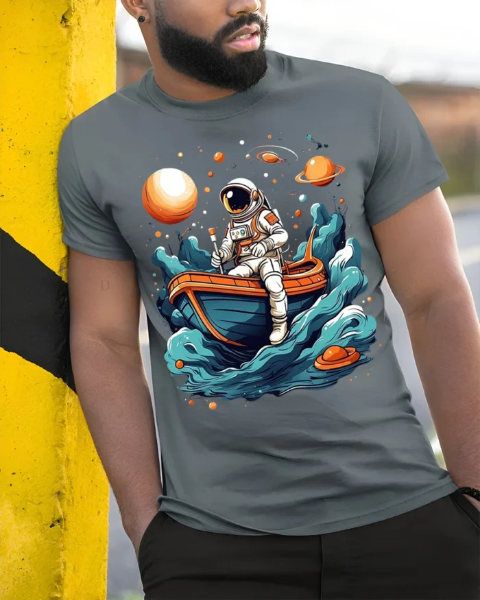 Astronaut Rowing Boat Space Adventure Graphic T-shirt - model in grey shirt leaning against column