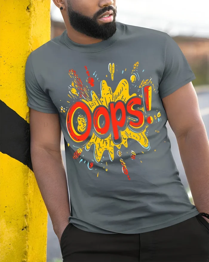 Oops Comic Splash Funny Graphic Style T-Shirt - model in grey shirt leaning against column