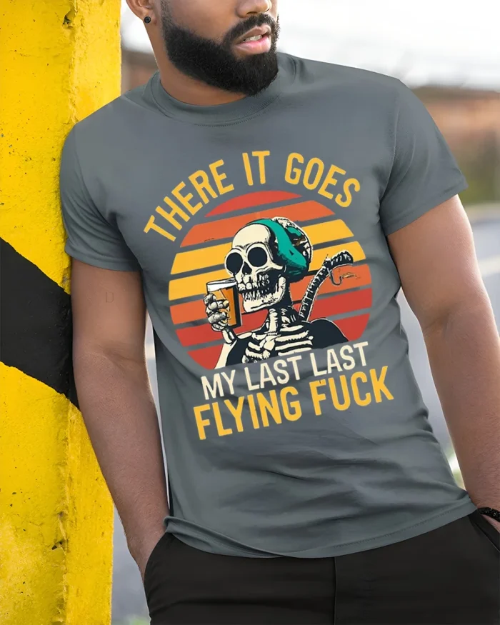 Skeleton Retro Sunset Funny Drinking Graphic T-Shirt - model in grey shirt leaning against column