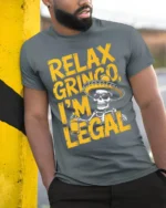 Funny Relax Gringo I’m Legal Skeleton Beer T-Shirt - model in grey shirt leaning against column