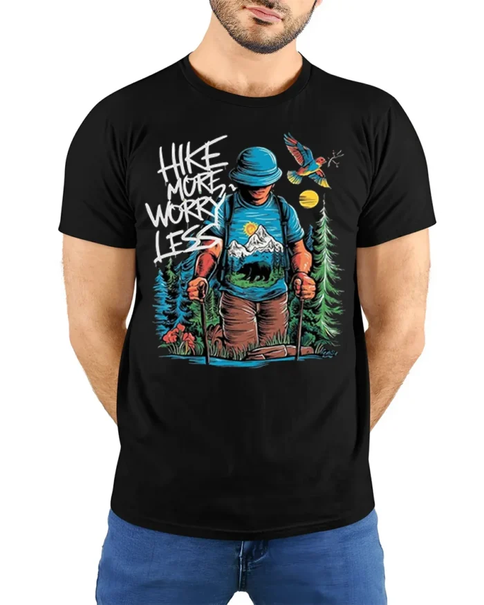 Hike More Worry Less Mountain Adventure T-shirt - model wearing black shirt, hands behind back