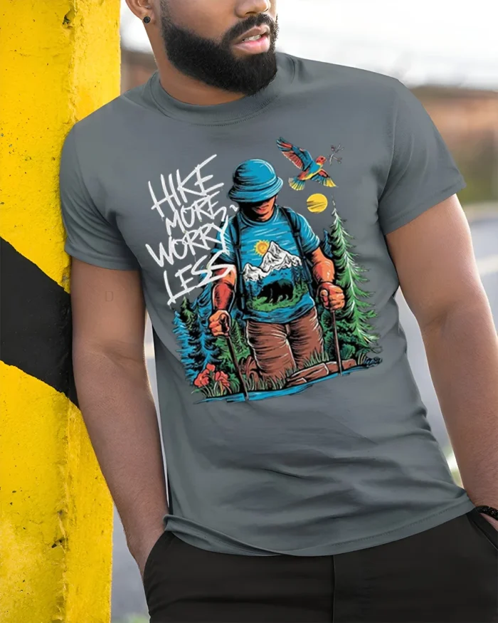 Hike More Worry Less Mountain Adventure T-shirt - model in grey shirt leaning against column