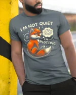 Funny Fox I’m Not Quiet I’m Plotting Graphic T-shirt - model in grey shirt leaning against column