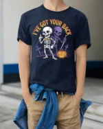 I’ve Got Your Back Funny Skeleton Halloween T-Shirt - model wearing navy shirt, hands in pockets