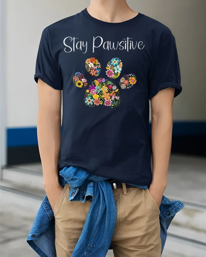 Stay Pawsitive Floral Paw Print T-Shirt - model wearing navy shirt, hands in pockets