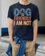 Dog Is Friendly I Am Not Funny Graphic T-Shirt - model wearing navy shirt, hands in pockets