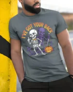 I’ve Got Your Back Funny Skeleton Halloween T-Shirt - model in grey shirt leaning against column