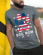 Proud Dog Mom USA Flag Paw Print Graphic T-Shirt - model in grey shirt leaning against column