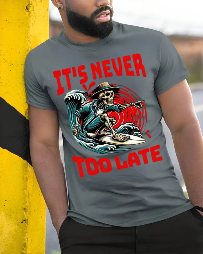 It’s Never Too Late Skeleton Surfer Graphic T-Shirt - model in grey shirt leaning against column