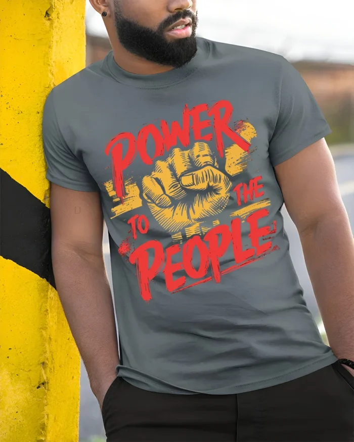 Power To The People Raised Fist Graphic T-Shirt - model in grey shirt leaning against column