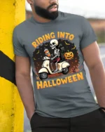Riding Into Halloween Skeleton Scooter T-Shirt - model in grey shirt leaning against column