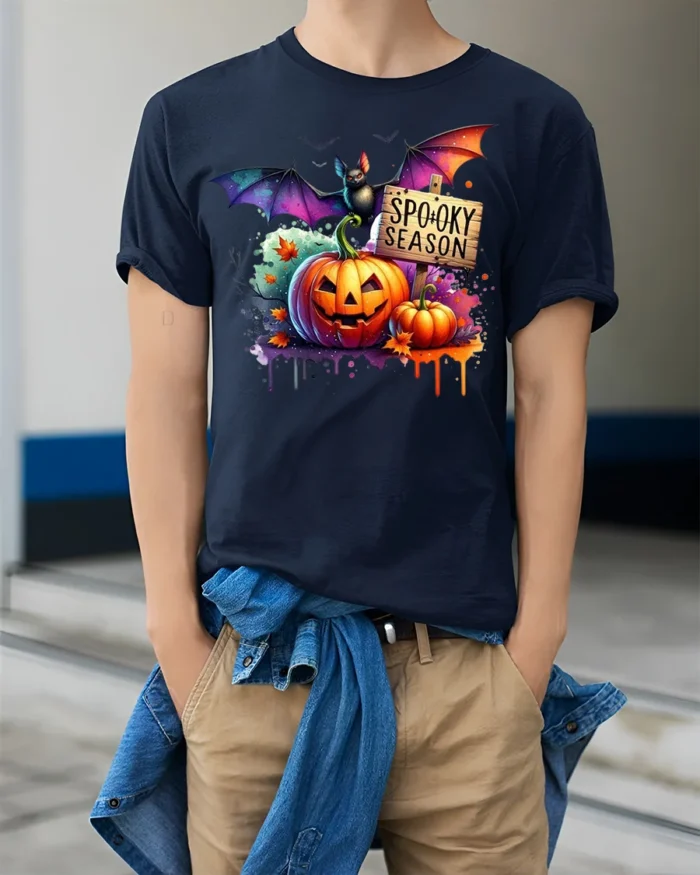 Halloween Spooky Season T-Shirt with Pumpkin Bat - model wearing navy shirt, hands in pockets