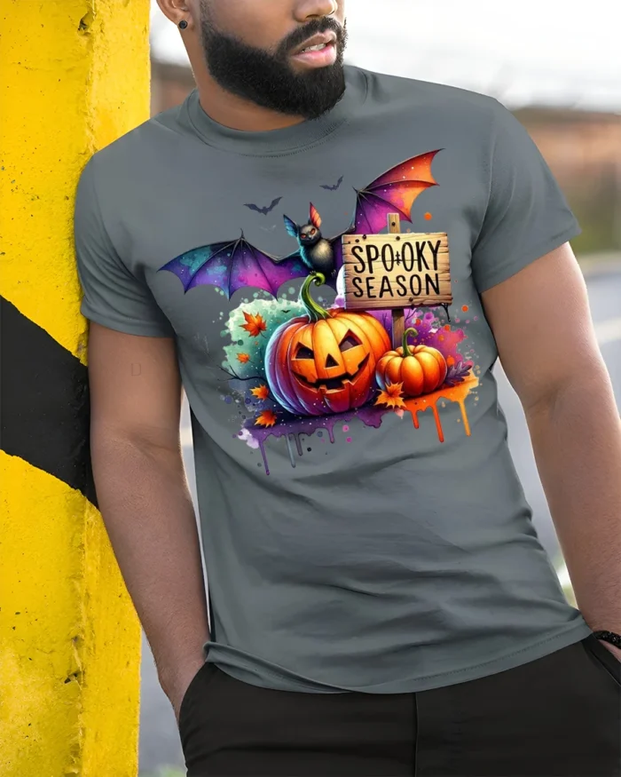 Halloween Spooky Season T-Shirt with Pumpkin Bat - model in grey shirt leaning against column