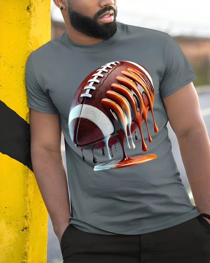 Dripping Football Game Day Graphic T-Shirt Black - model in grey shirt leaning against column