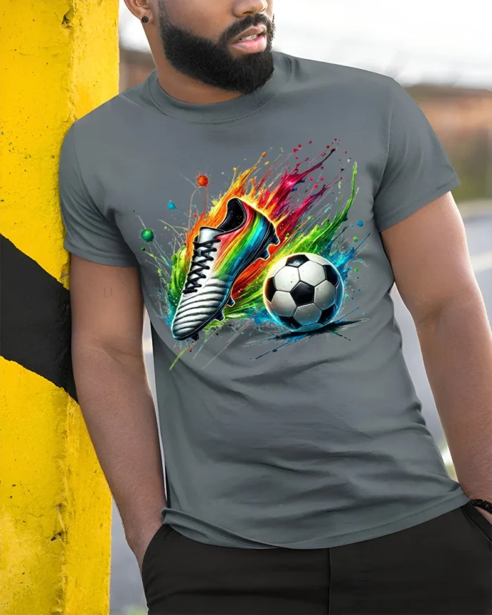 Colorful Soccer Shoe and Ball Splash Graphic T-Shirt - model in grey shirt leaning against column