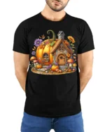 Pumpkin House Halloween Fall Cottage T-shirt - model wearing black shirt, hands behind back