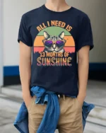 All I Need Is Sunshine Cat Tshirt Retro Summer Tee - model wearing navy shirt, hands in pockets