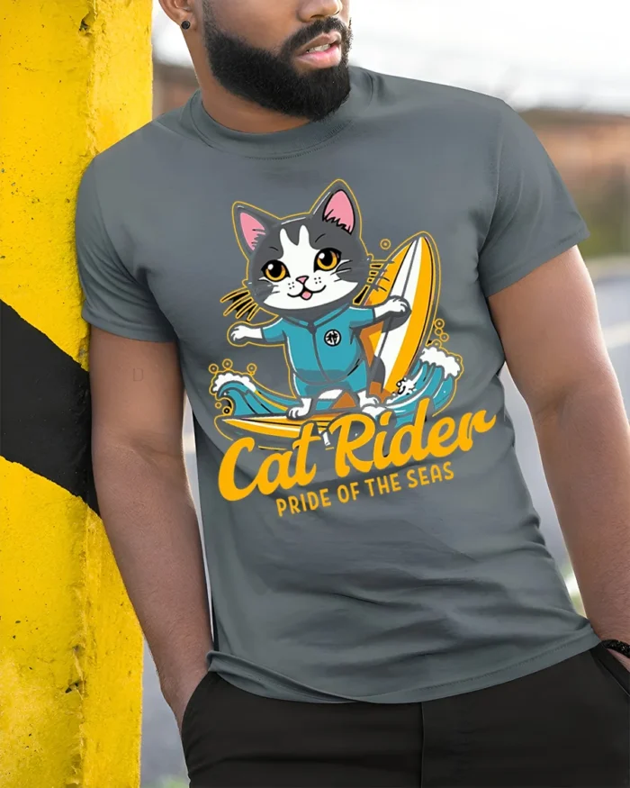Cat Rider Surfing Graphic T-Shirt for Ocean Lovers - model in grey shirt leaning against column