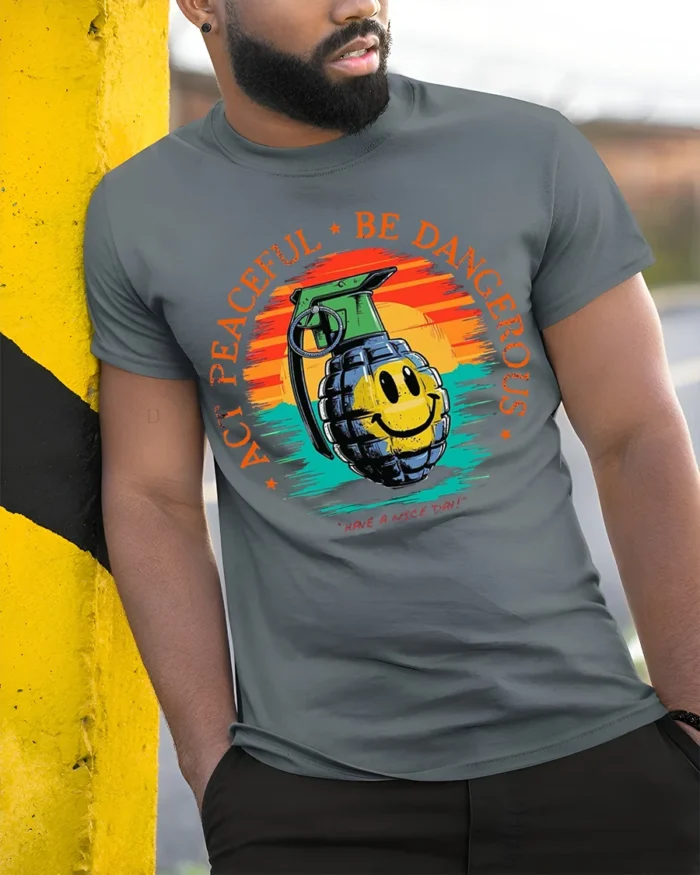 Act Peaceful Be Dangerous Graphic T-Shirt Tee - model in grey shirt leaning against column