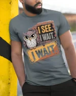 I See I Wait Owl Graphic Funny Quote T-Shirt - model in grey shirt leaning against column