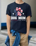 Patriotic Dog Mom USA Flag Paw Print Graphic T-Shirt - model wearing navy shirt, hands in pockets